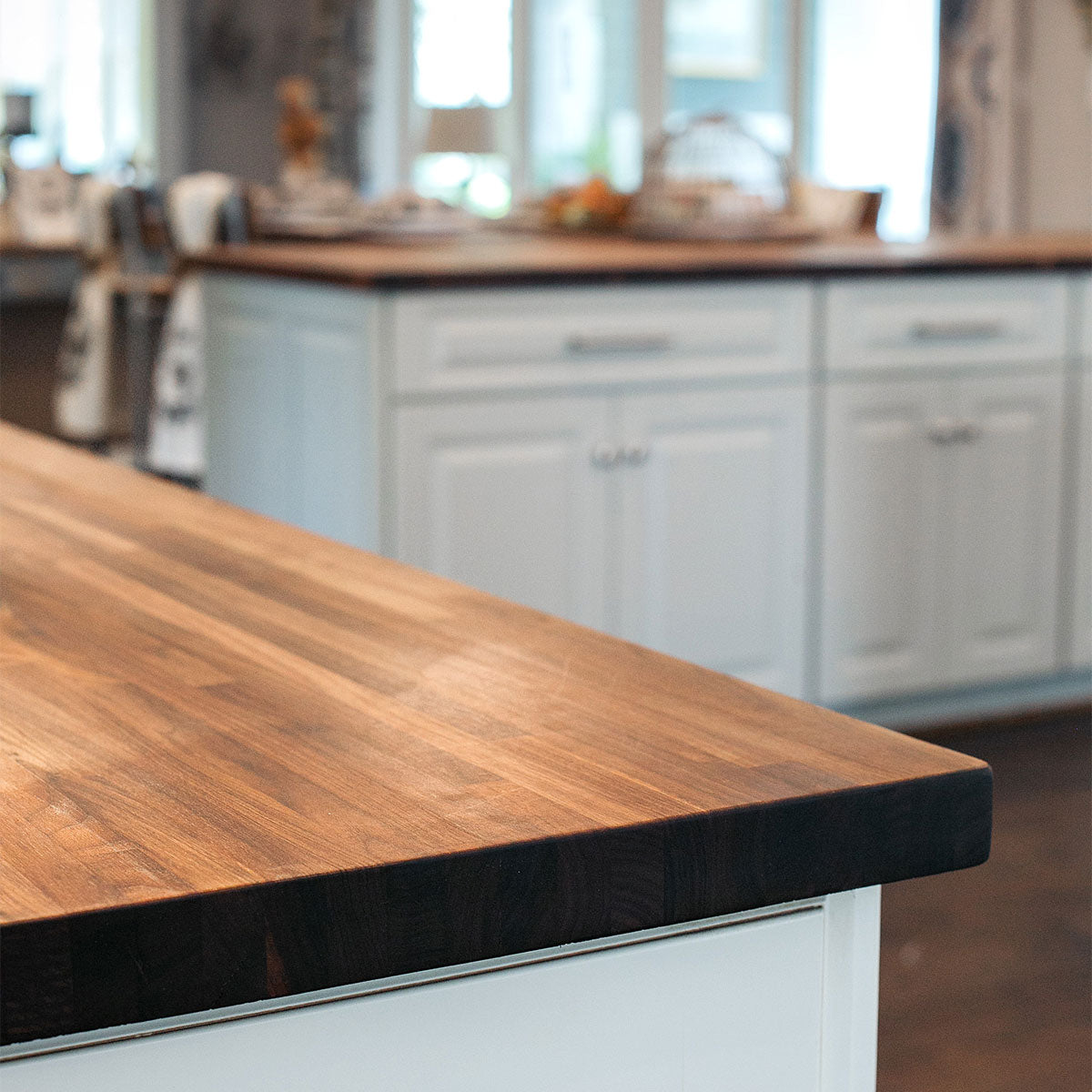Walnut counter top in a kitchen with white cabinets