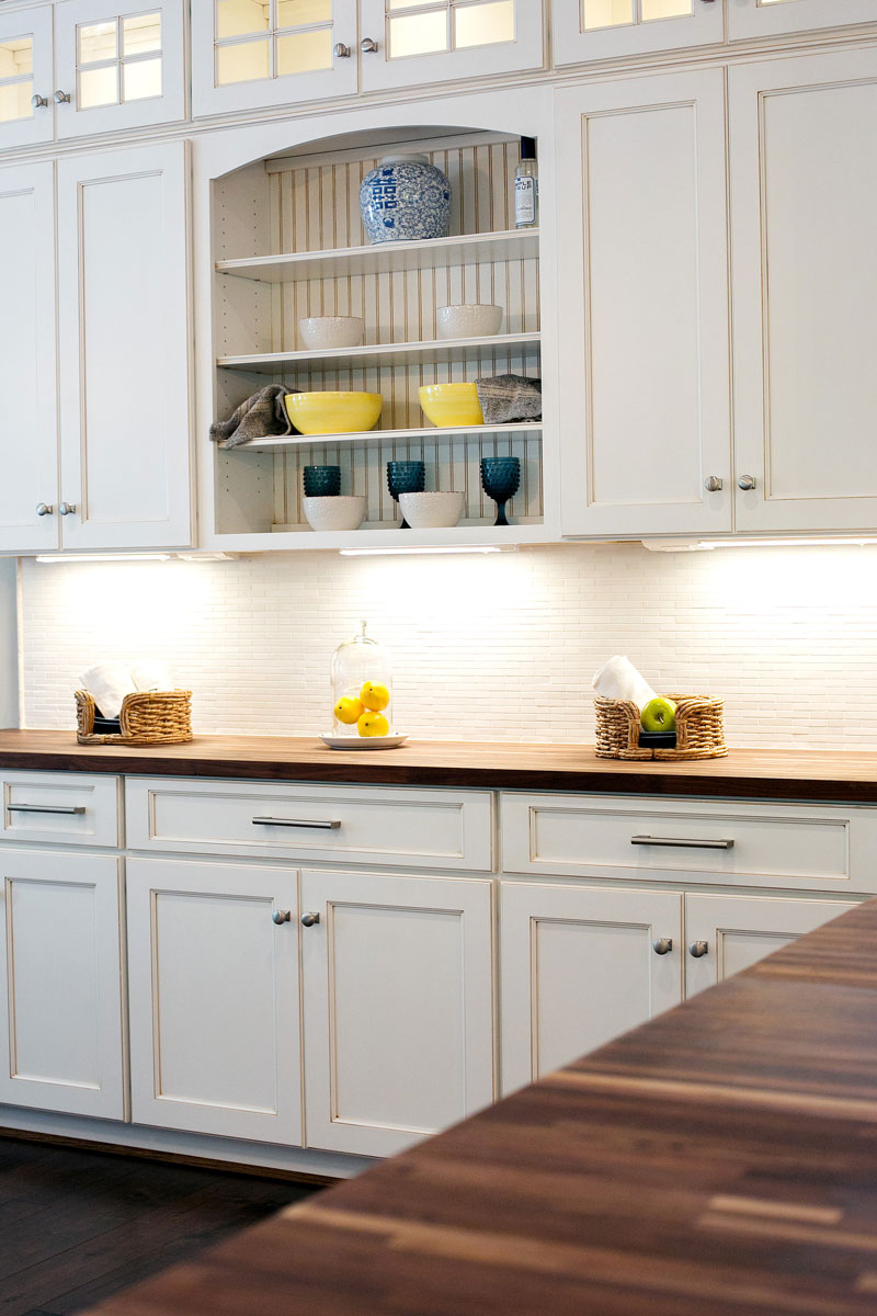 Walnut butcher block countertops in a kitchen with white cabinets